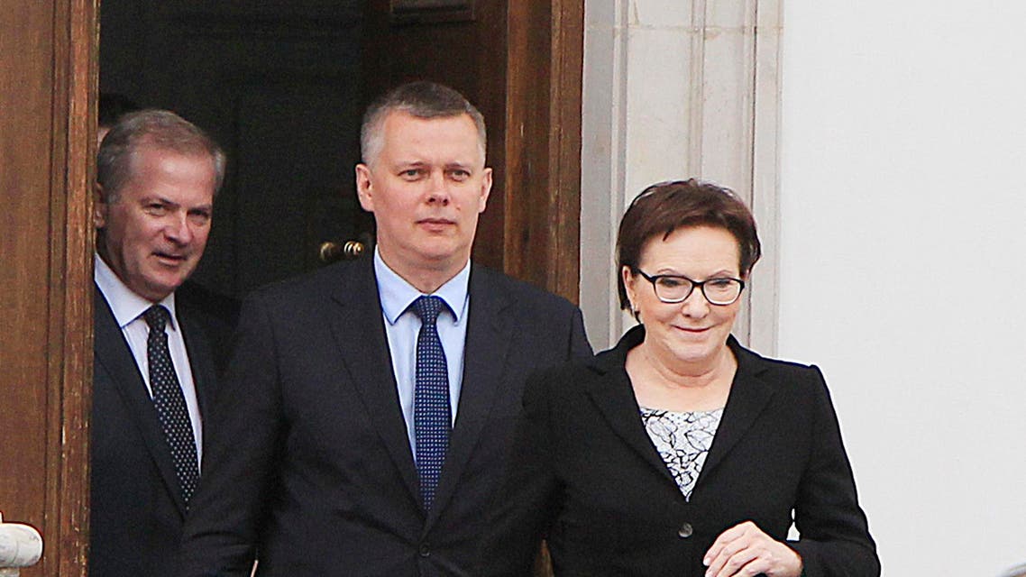 Polish Prime Minister Ewa Kopacz, right, and her deputy, Defense Minister Tomasz Siemoniak, center, leaving the Belvedere Palace in Warsaw, Poland, on Monday, June 15, 2015 AP