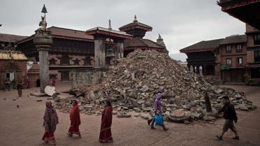 In this photograph taken on April 30, 2015, pedestrians walk past damaged temples at the UNESCO world heritage site of Bhaktapur on the outskirts of the Nepalese capital Kathmandu, following a 7.8 magnitude earthquake which struck the Himalayan nation on April 25. AFP