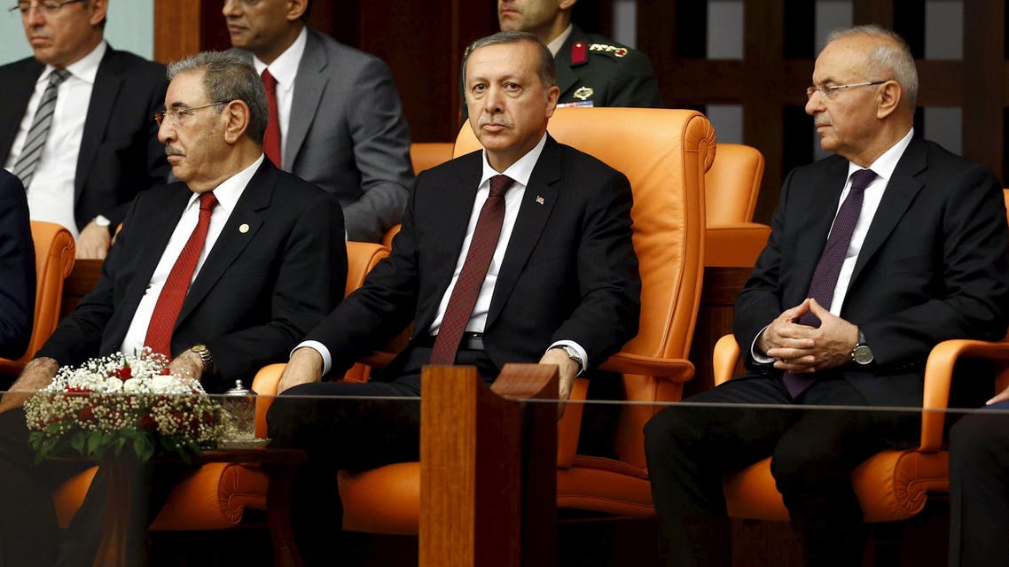 Turkey's President Tayyip Erdogan (front row, C), flanked by parliamentarian Seyit Eyuboglu (front row, L) and Presidency Secretary-General Fahri Kasirga (R), watches a swearing-in ceremony at the Turkish parliament in Ankara, Turkey, June 23, 2015 (Reuters)
