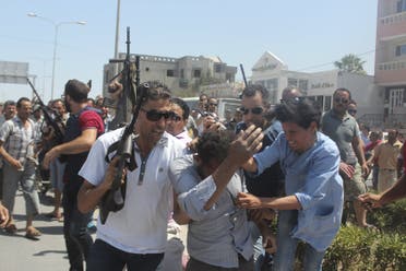 Police officers control the crowd (rear) while surrounding a man (front C) suspected to be involved in opening fire on a beachside hotel in Sousse, Tunisia, as a woman reacts(R), June 26, 2015. Reuters