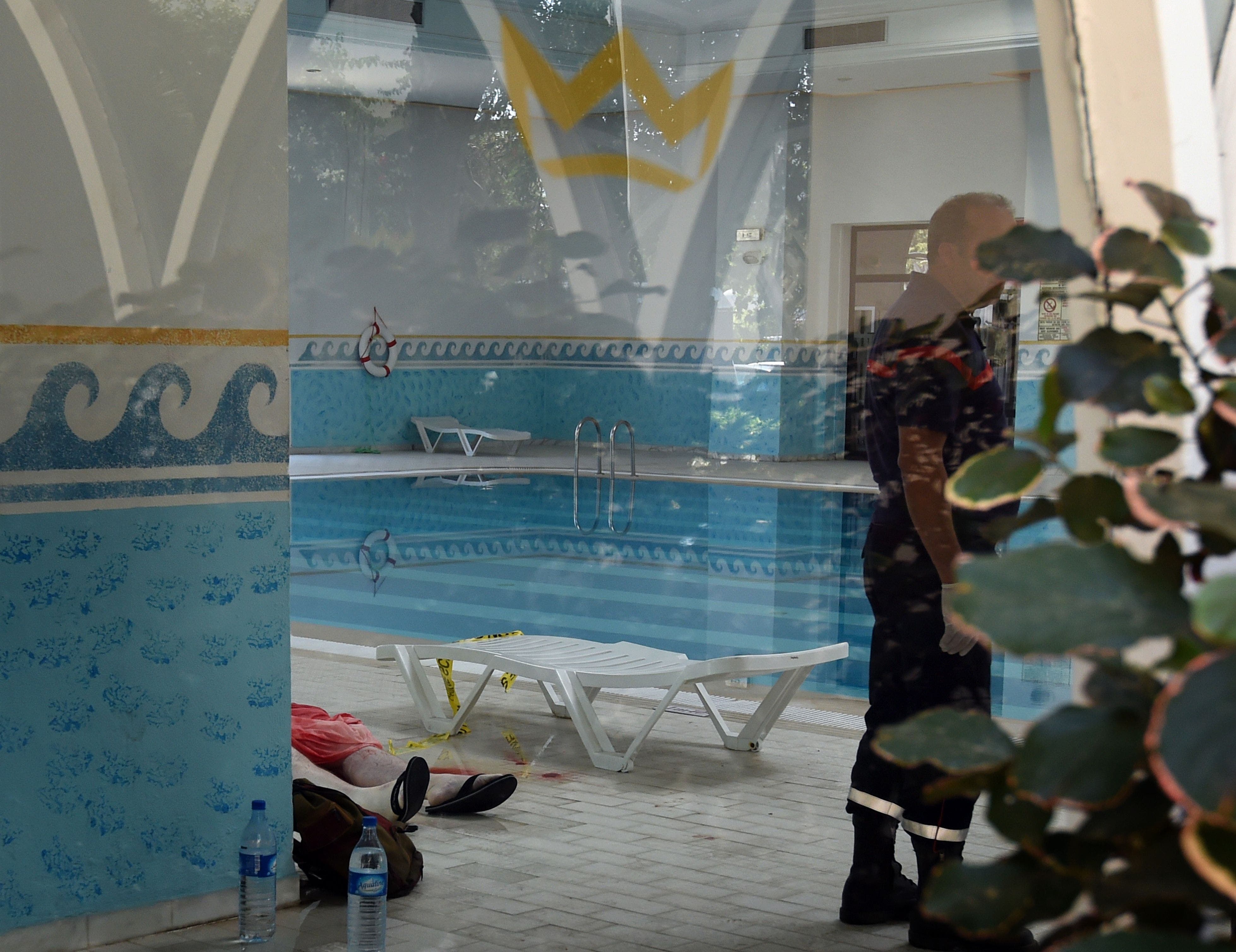 A Tunisian medic stands next to the body of a tourist at the Imperial hotel in the resort town of Sousse,
