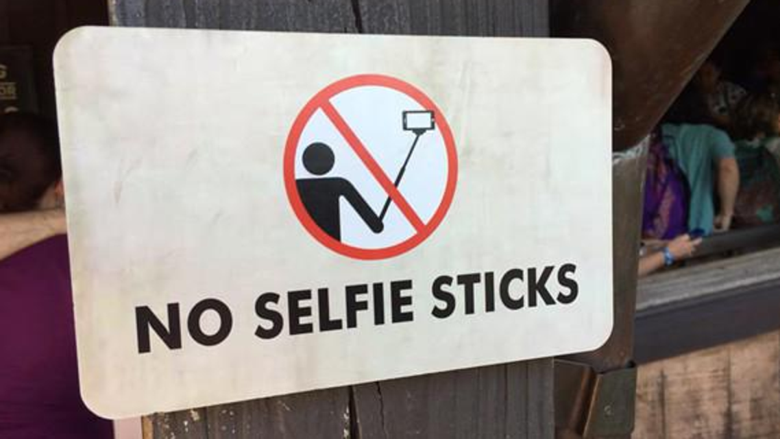 Starting next week, security personnel will ask Disney guests who arrive with selfie sticks at the parks to stow them at a storage facility. (Courtesy of Twitter)