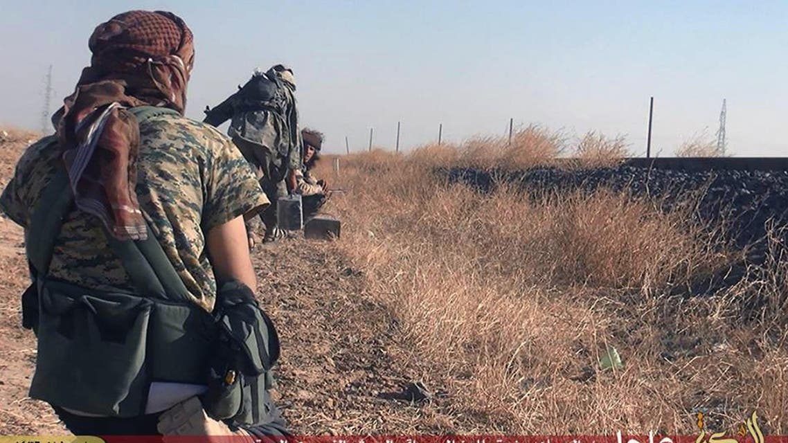 In this photo provided by a website of the ISIS militants, taken Thursday, June 25, 2015, ISIS militants move toward Syrian government forces' positions in the predominantly Kurdish Syrian city of Hassakeh, Syria. (AP)