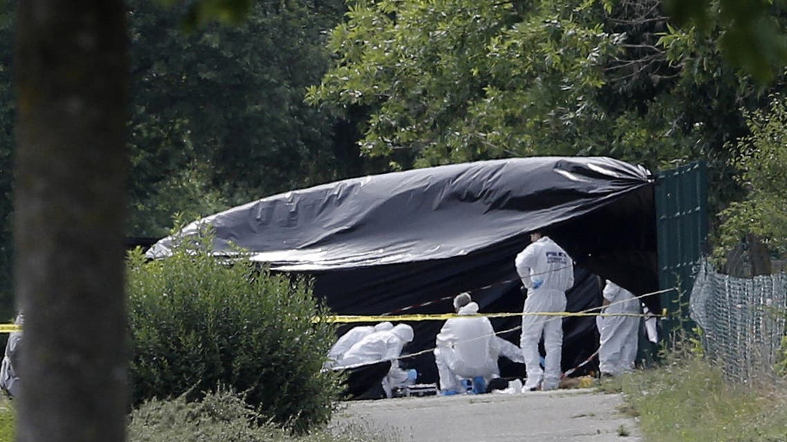 Police officers investigate at a plant where an attack took place, Friday, June 26, 2015 in Saint-Quentin-Fallavier, southeast of Lyon, France. AP
