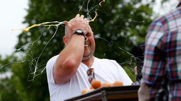 A man loses in a game of Russian Egg Roulette during the World Egg Throwing Championships and Vintage Day in Swaton, Britain June 28, 2015. REUTERS