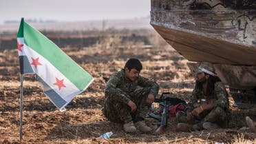 Fighters from the Free Syrian Army's Al-Tahrir Brigade, rest near their flag on the eastern outskirts of the city of Tel Abyad of Raqqa governorate after they said they took control of the area June 15, 2015. (Reuters)