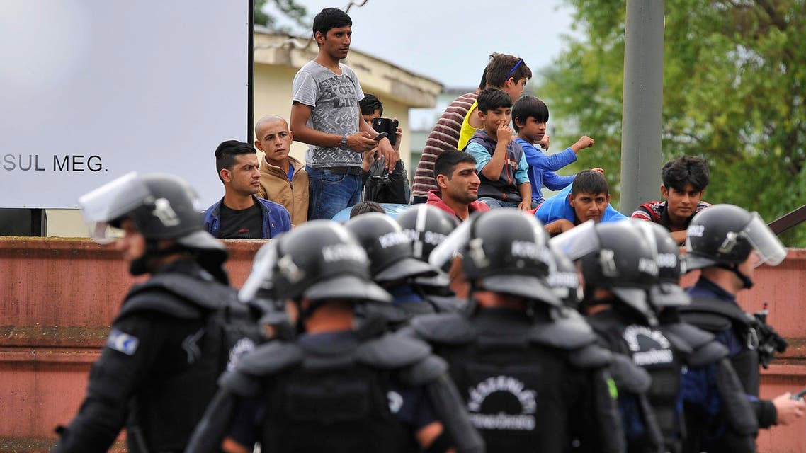 Policemen stand at the entrance of the Debrecen refugee camp in Debrecen, 230 kms from Budapest, Hungary, Monday, June 29, 2015. AP