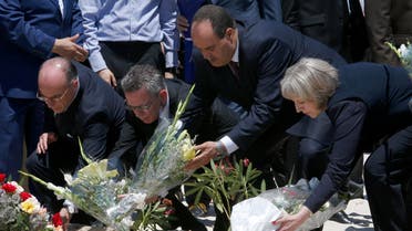 From right to left British Home Secretary Theresa May, Tunisian Interior Minister Mohamed Najem Gharsalli, , German Interior Minister Thomas de Maiziere and French Interior Minister Bernard Cazeneuve lay flowers on the beach in front of the Imperial Marhaba hotel in the Mediterranean resort of Sousse for the tribute in Sousse, Tunisa, Monday, June 29, 2015. AP
