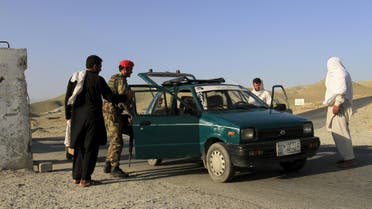 Afghan National Army (ANA) soldiers check a vehicle at a checkpoint on the outskirts of Jalalabad, June 29, 2015.