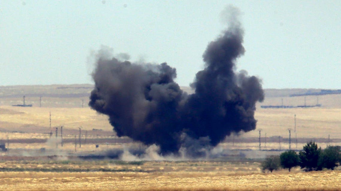In this photo taken from the Turkish side of the border between Turkey and Syria, in Akcakale, Sanliurfa province, southeastern Turkey, smoke from a US-led airstrike rises over the outskirts of Tal Abyad, Syria, Sunday, June 14, 2015. Syrian Kurdish fighters closed in on the outskirts of a strategic Islamic State-held town on the Turkish border Sunday, Kurdish officials and an activist group said, potentially cutting off a key supply line for the extremists' nearby de facto capital. Taking Tal Abyad, some 80 kilometers (50 miles) from the Islamic State stronghold of Raqqa, would mean the group wouldn't have a direct route to bring in new foreign militants or supplies.(AP Photo/Lefteris Pitarakis)