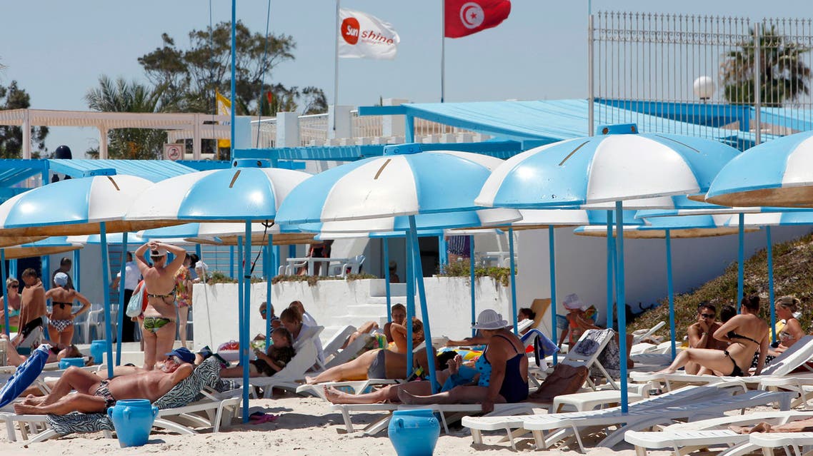 Tourists sunbathe at the Mediterranean resort of Sousse, Tunisa, four days after Friday's terrorist attack, Tuesday, June 30, 2015. One of Tunisia's top security officials says the gunman who killed 38 tourists, mostly Britons, in a beach attack was trained in neighboring Libya at the same time as the attackers who targeted the Bardo museum in March. (AP Photo/Abdeljalil Bounhar)