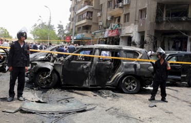 Policemen investigate the site of a car bomb attack on the convoy of Egyptian public prosecutor Hisham Barakat near his house at Heliopolis district in Cairo, Egypt, June 29, 2015. 