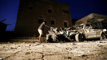 A man checks the wreckage of a car at the site of a car bomb attack in Yemen's catpital Sanaa June 17, 2015. (Reuters)