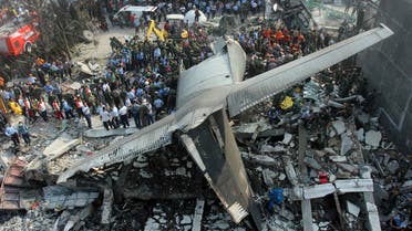 Rescuers search for victims at the site where an air force cargo plane crashed in Medan, North Sumatra, Indonesia, Tuesday, June 30, 2015. AP