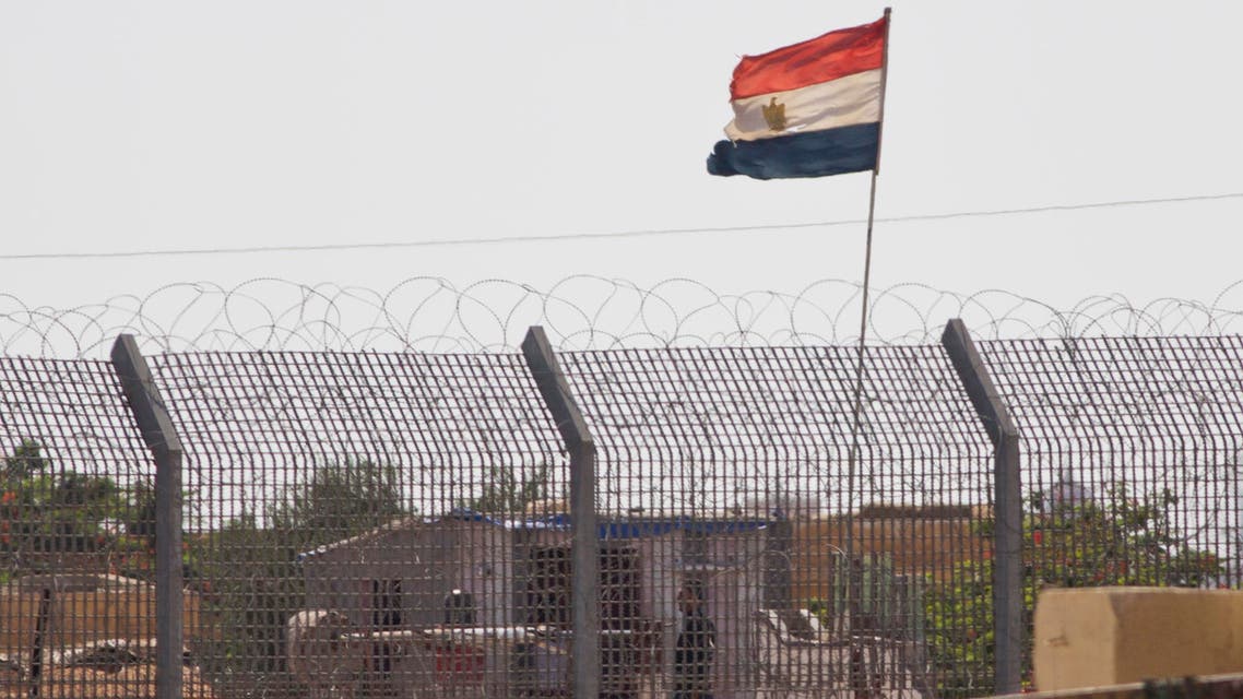 An Egyptian military officer watches at a post in Egypt's northern Sinai Peninsula, as seen from the Israel-Egypt border, in Kerem Shalom village, southern Israel, Wednesday, July 1, 2015. AP