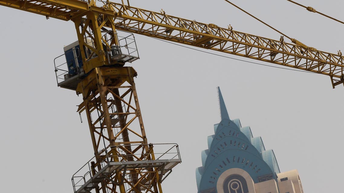 A crane on a construction company on a high-rise building in Dubai, United Arab Emirates, Wednesday, July 2, 2014. 