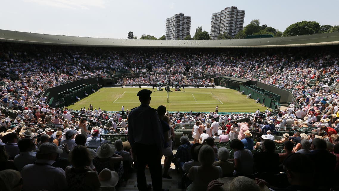 Spectators on No. 1 Court watch the match between Milos Raonic of Canada and Tommy Haas of Germany at the All England Lawn Tennis Championships in Wimbledon, London, Wednesday July 1, 2015. (AP)
