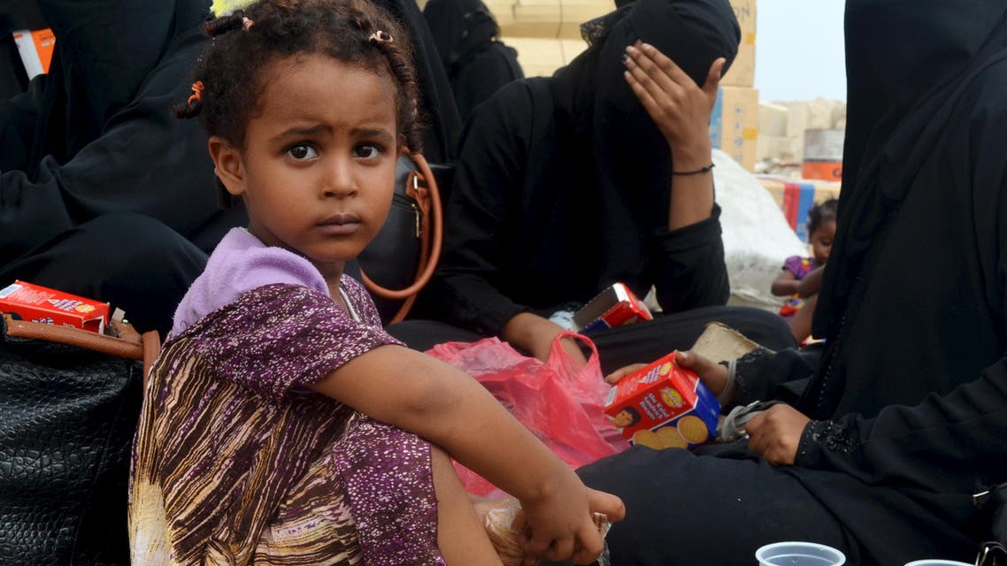 Child sits with her family as refugees fleeing the ongoing violence in Yemen