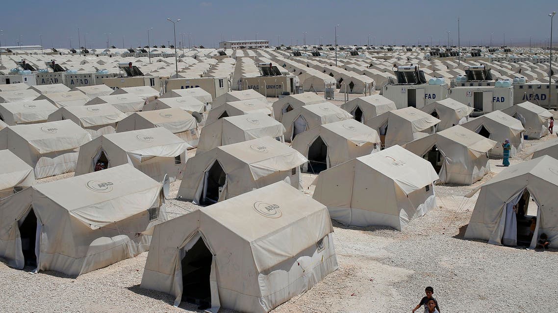 Syrian refugees wander around a refugee camp in Suruc, on the Turkey-Syria border, Friday, June 19, 2015.