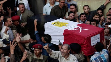 Egyptians carry the coffin of 1st Lt. Mohammed Adel Abdel Azeem, killed in Wednesday's attack by Islamic militants in the Sinai, during the funeral procession at his home village Tant Al Jazeera in Qalubiyah, north of Cairo, Egypt, Thursday, July 2, 2015. AP