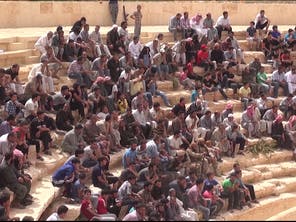 A crowd look on as the death sentence is read to the 25 Syrian soldiers in the ancient Palmyra amphitheater (Video grab)
