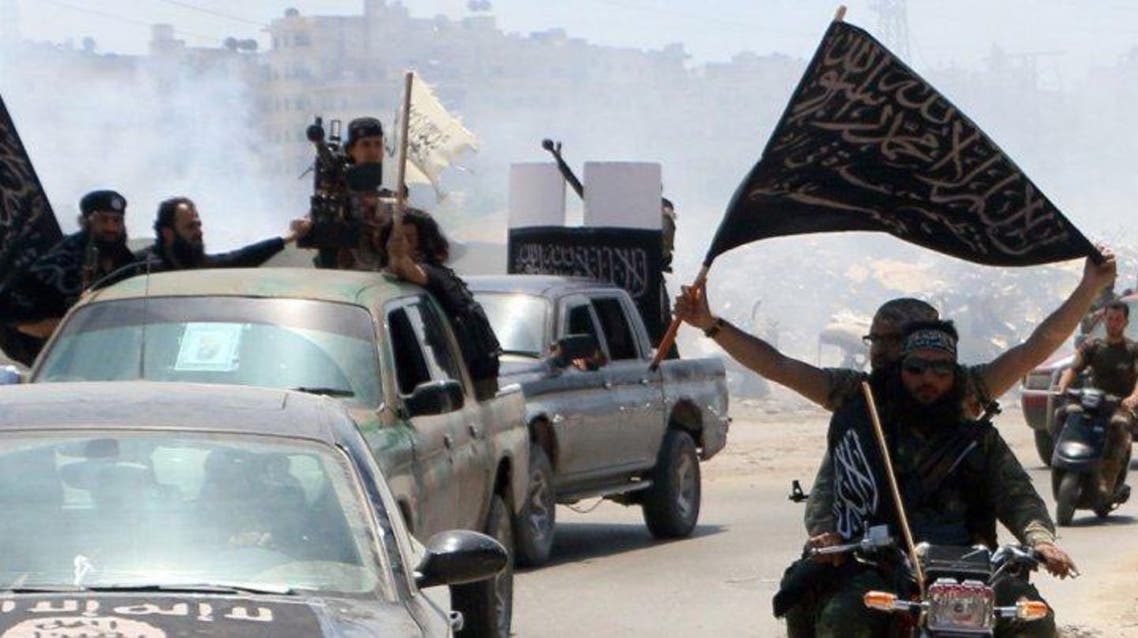 Fighters from al Qaeda's Syrian affiliate Al-Nusra Front drive in the northern Syrian city of Aleppo flying Islamist flags as they head to a frontline, on May 26, 2015 (AFP)