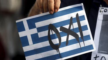 A man holds a sign that reads, "No", supporting Greece during a pro-Greece protest in front of European Union office in Barcelona, Spain. (Reuters)