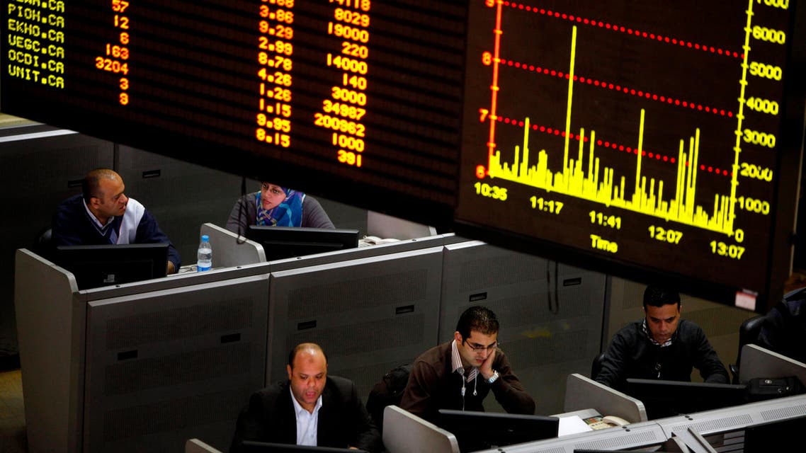 In this Jan. 21, 2013 file photo, Egyptian traders work at the stock market in Cairo, Egypt. Egypt’s government on Monday, May 18, 2015, suspended a tax imposed on the market’s capital gains, for two years causing shares to rise in early trading. The suspension comes nearly a year after President Abdel-Fattah el-Sissi approved the law, which put 10 percent tax on capital gains that fueled a sell-off by investors. Some investors went to courts to abolish government’s law. (AP Photo/Amr Nabil, File)