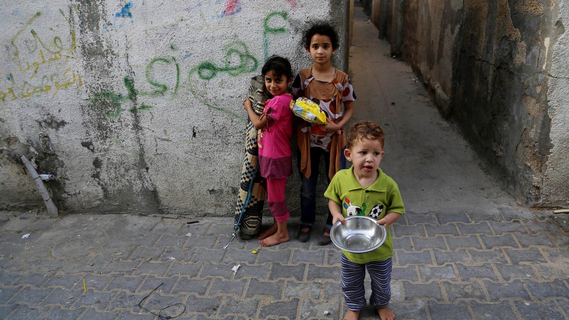 Palestinian children pose for a photo in Jebaliya refugee camp in the northern Gaza Strip, Thursday, May 14, 2015. AP