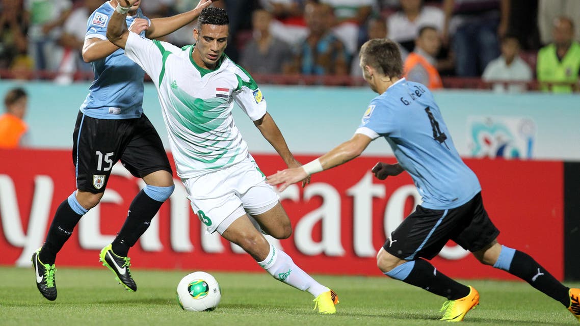 Iraq's Ali Adnan, center, dribbles between Uruguay's Guilermo Varela, right, and Gino Acevedo, during their Under-20 World Cup semifinal soccer match at the Huseyin Avni Aker stadium in Trabzon, Turkey, Wednesday, July 10, 2013. (AP Photo/Thanassis Stavrakis)
