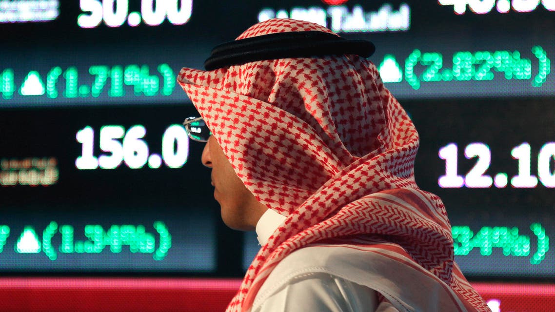 A Saudi man walks at the Tadawul Saudi Stock Exchange, in Riyadh, Saudi Arabia, Monday, June 15, 2015. Saudi Arabia's stock market, valued at $585 billion, opened up to direct foreign investment for the first time Monday, as the kingdom seeks an economic boost amid low global oil prices. (AP Photo/Hasan Jamali)