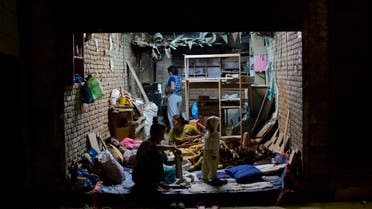 A family gathers on the ground level of their house to rest for the night in Kathmandu, Nepal, Tuesday, May 12, 2015.