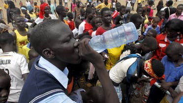 A refugee from South Sudan drinks water at a well during celebrations to mark World Refugee Day at the Kakuma refugee camp in Turkana District, northwest of Kenya's capital Nairobi, June 20, 2015. June 20 is World Refugee Day, an occasion that draws attention to those who have been displaced around the globe. REUTERS/Thomas Mukoya
