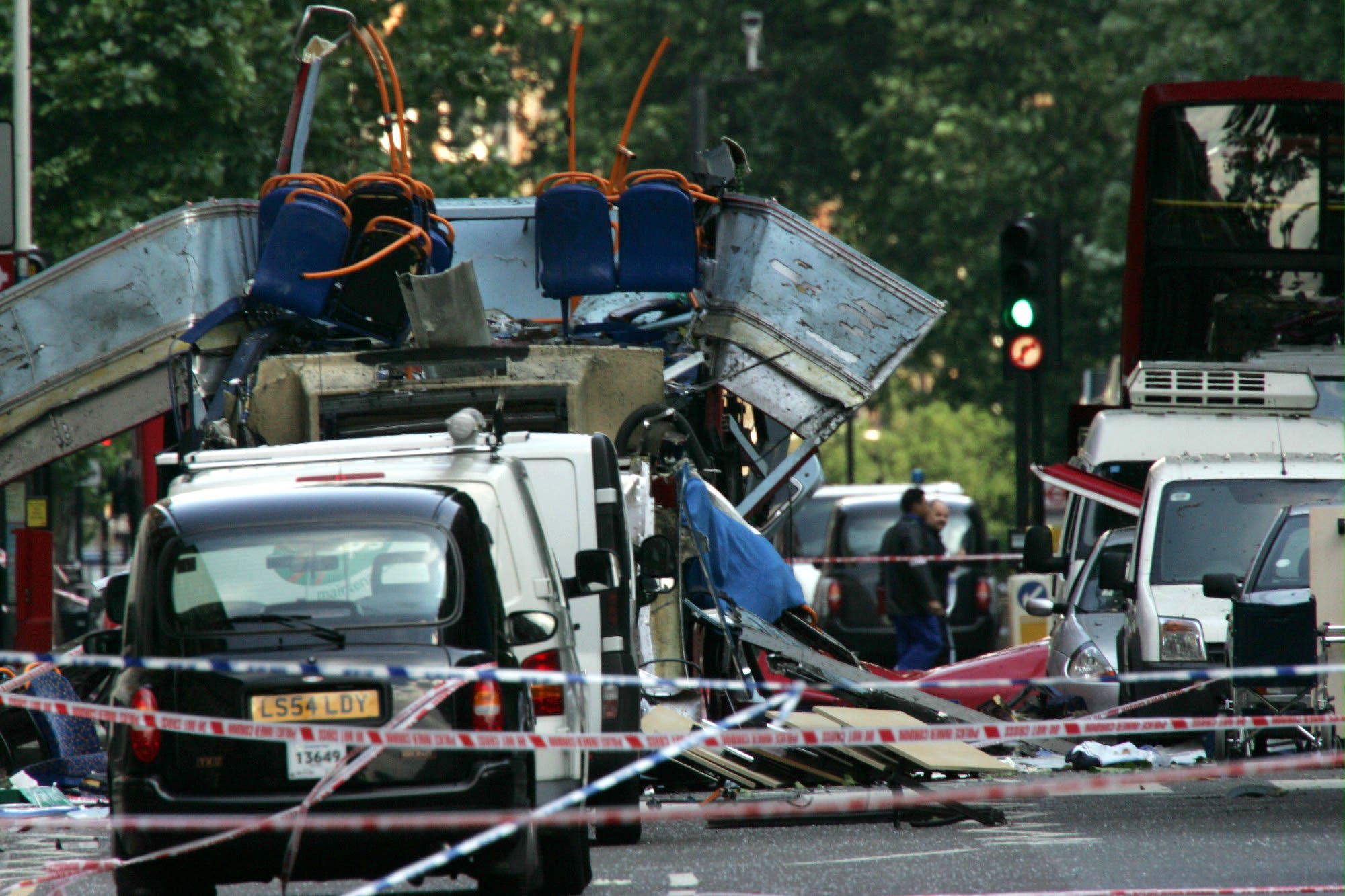 The wreckage of a double-decker bus with its top blown off and damaged cars scattered on the road at Tavistock Square in central London in this July 7, 2005. (File Photo:AP)