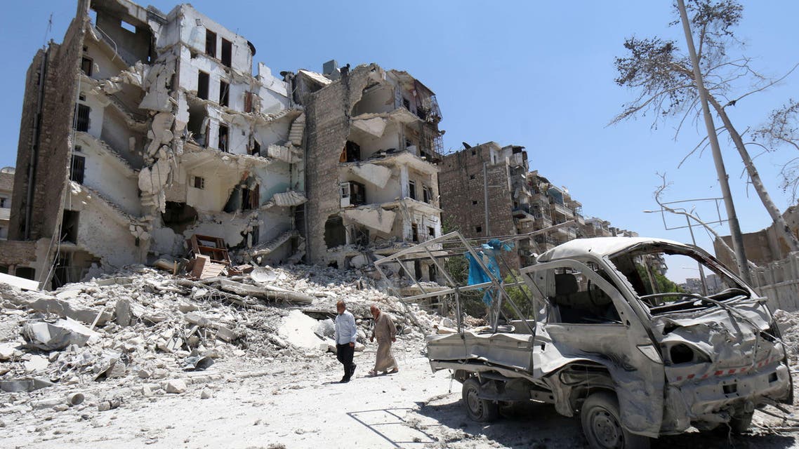 Syrian men walk amidst the rubble and debris in the Qadi Askar district of the northern Syrian city of Aleppo on July 5, 2015. (File Photo: AFP)