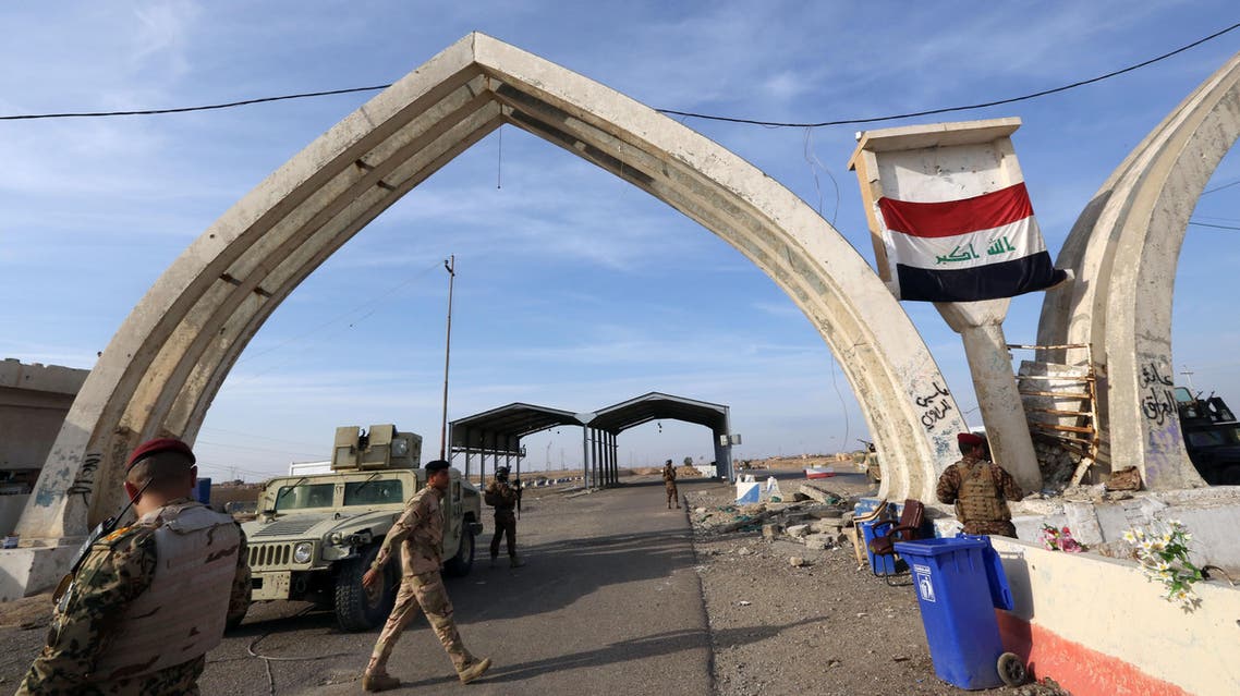 In this file photo taken Monday, Dec. 8, 2014, Iraqi security forces and Shiite fighters are deployed during a military operation to regain control of the university of Tikrit, 80 miles (130 kilometers) north of Baghdad, Iraq. AP