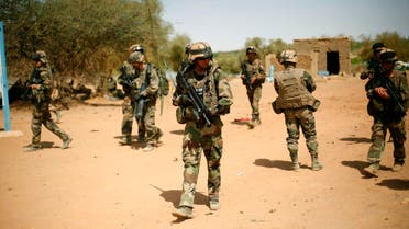 In this Feb.10, 2013 file photo, French soldiers secure the area where a suicide bomber attacked, at the entrance of Gao, northern Mali. AP