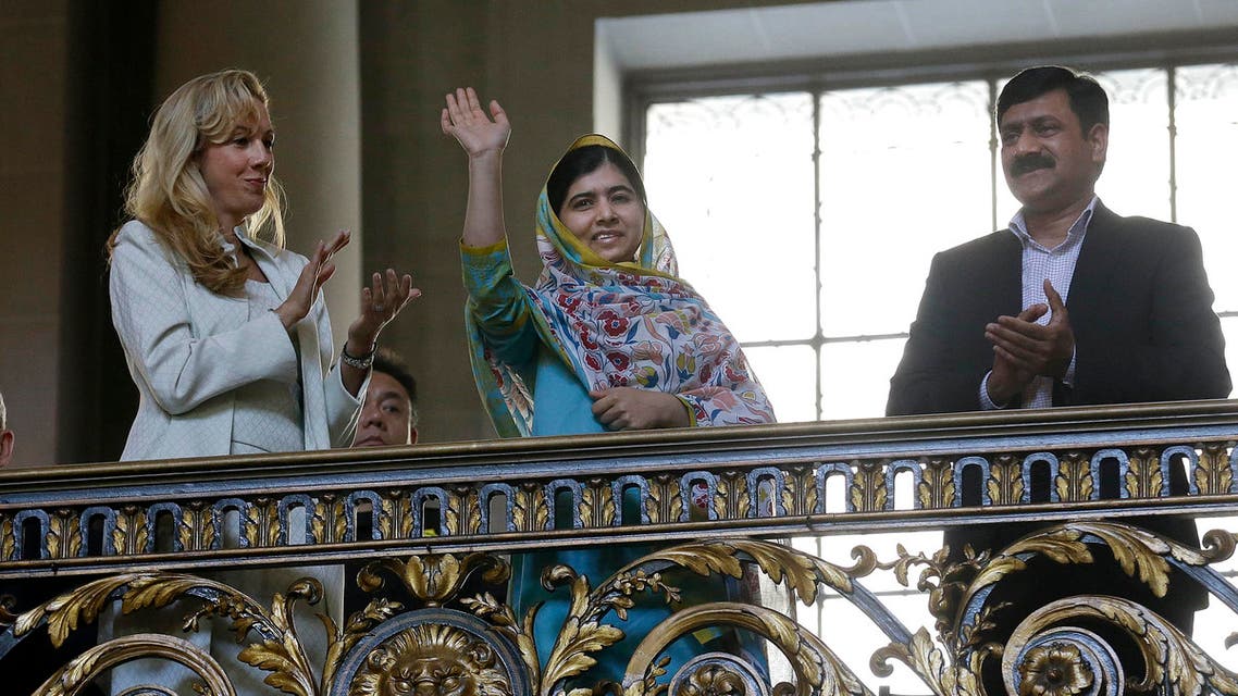 Nobel Peace Prize recipient Malala Yousafzai, center, waves while introduced at a ceremony for the 70th anniversary of the United Nations in San Francisco, Friday, June 26, 2015.