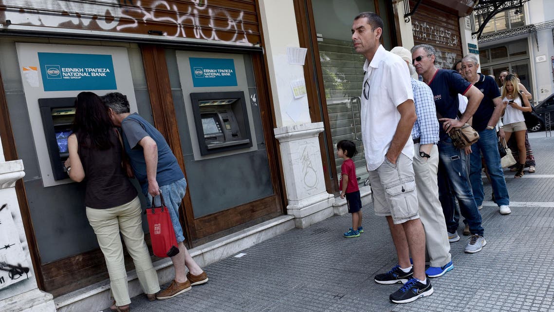 People stand in queue to use an ATM in the northern Greek port city of Thessaloniki, Thursday, July 9, 2015. AP