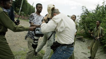 A photogrpaher is beaten by Ethiopian police outside the house of Hailu Shawul the leader opposition party the Coalition for Unity and Democracy in Addis Ababa Saturday June 11, 2005. AP