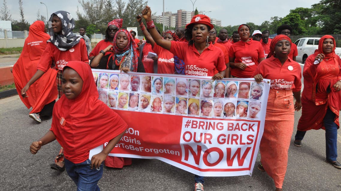 People take part in a march that is part of the 'Bring Back Our Girls' campaign, in memory of the Nigerian girls abducted by Nigerian extremists, outside the presidential residence in Abuja, Nigeria, Wednesday, July 8, 2015. Nigeria's Boko Haram extremists are offering to free more than 200 young women and girls kidnapped from a boarding school in the town of Chibok in exchange for the release of militant leaders held by the government, a human rights activist has told The Associated Press. (AP Photo/Olamikan Gbemiga)