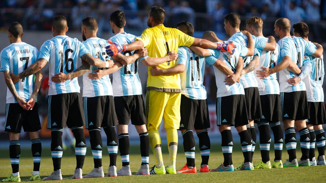 Argentina's players embrace during a minute of silence in remembrance of Chilean motorcycle pilot Carlos de Gavardo, before the Copa America final soccer match against Chile at the National Stadium in Santiago, Chile, Saturday, July 4, 2015. (AP Photo/Luis Hidalgo)