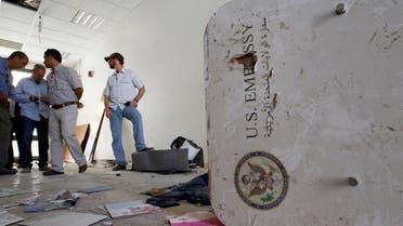 A U.S. embassy emblem is seen on a broken door during a visit for the press in the vandalized U.S. Embassy in Tripoli, Libya, Monday, Sept. 12, 2011. (File Photo: AP) 