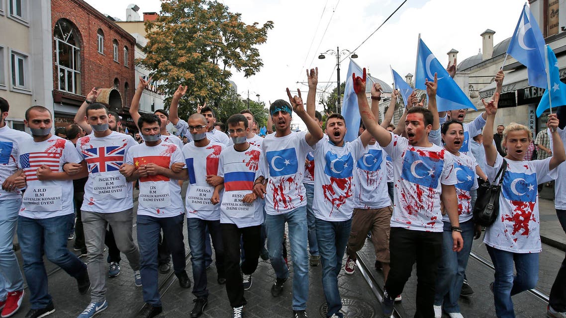 Uighurs living in Turkey and their supporters wear T-shirts with fake blood, representing Uighurs who have died in China's far-western Xinjiang Uighur region, during a protest in Istanbul, Saturday, July 4, 2015, against what they call as oppression by Chinese government to Muslim Uighurs in the province. Hundreds of people have marched in Istanbul to protest China over reports of its repression of its minority Muslim Uighur community. Turkey has ethnic and linguistic ties to the Uighurs, members of a Muslim ethnic minority in Xinjiang. Relations between China and Turkey have been strained over Turkish reports that Uighurs were banned from worshipping and fasting during the Muslim holy month of Ramadan. (AP Photo/Emrah Gurel)