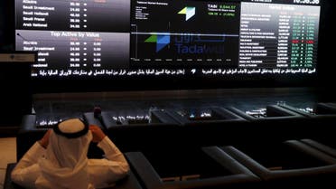 A trader monitors screens displaying stock information at the Saudi Stock Exchange (Tadawul) in Riyadh. (File: Reuters)