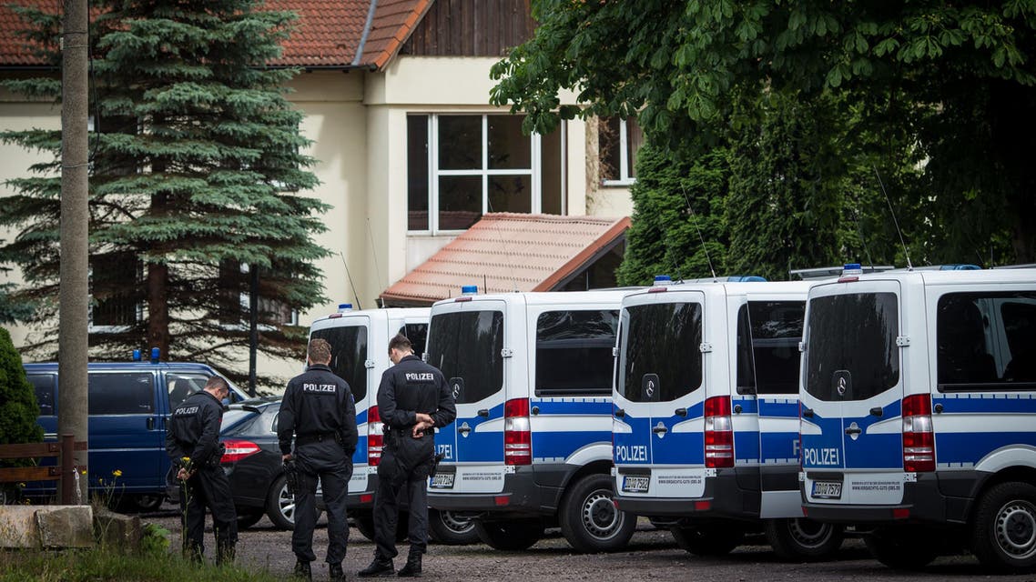 In this June 24, 2015 photo police stand in front of a hotel where migrants are accommodated in Freital near Dresden, eastern Germany. Members of Pegida, the right-wing movement that’s staged regular rallies in Dresden and elsewhere against immigrants and Muslims, helped initiate the protests and demonstrated against the arrival of the first refugee families with shouting and slurs, German news agency dpa reported. (Oliver Killig/dpa via AP)