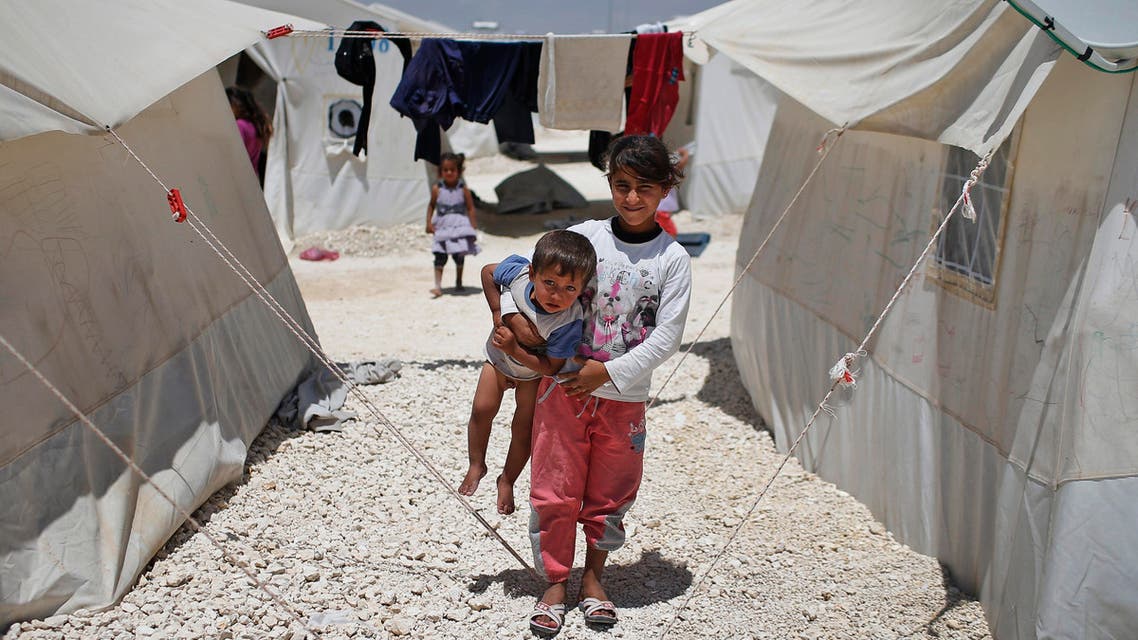 Syrian refugee children play at a refugee camp in Suruc, on the Turkey-Syria border, Friday, June 19, 2015. Ahead of World Refugee Day on Saturday, June 20, 2015, the UN refugee agency, UNHCR, estimated that a total of 11.6 million people from Syria had been displaced by the conflict by the end of last year, the largest such figure worldwide. Turkey is the world's biggest refugee host with 1.59 million refugees, according to the most recent U.N. figures. (AP Photo/Emrah Gurel)
