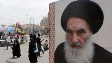 Shiite pilgrims make their way to the shrine of Imam Moussa al-Kadhim as passing by a poster of Shiite spiritual leader Grand Ayatollah Ali al-Sistani, right, in Baghdad, Iraq, Thursday, May 22, 2014. AP