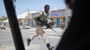 A Somali soldier runs during fighting following a car bomb that was detonated at the gates of a government office complex in the capital Mogadishu, Somalia Tuesday, April 14, 2015 AP