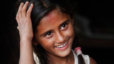 Salina Dahal smiles at her home in Dahal Village, 48 kilometers (30 miles) east of Kathmandu, Nepal, Friday, July 10, 2015. AP
